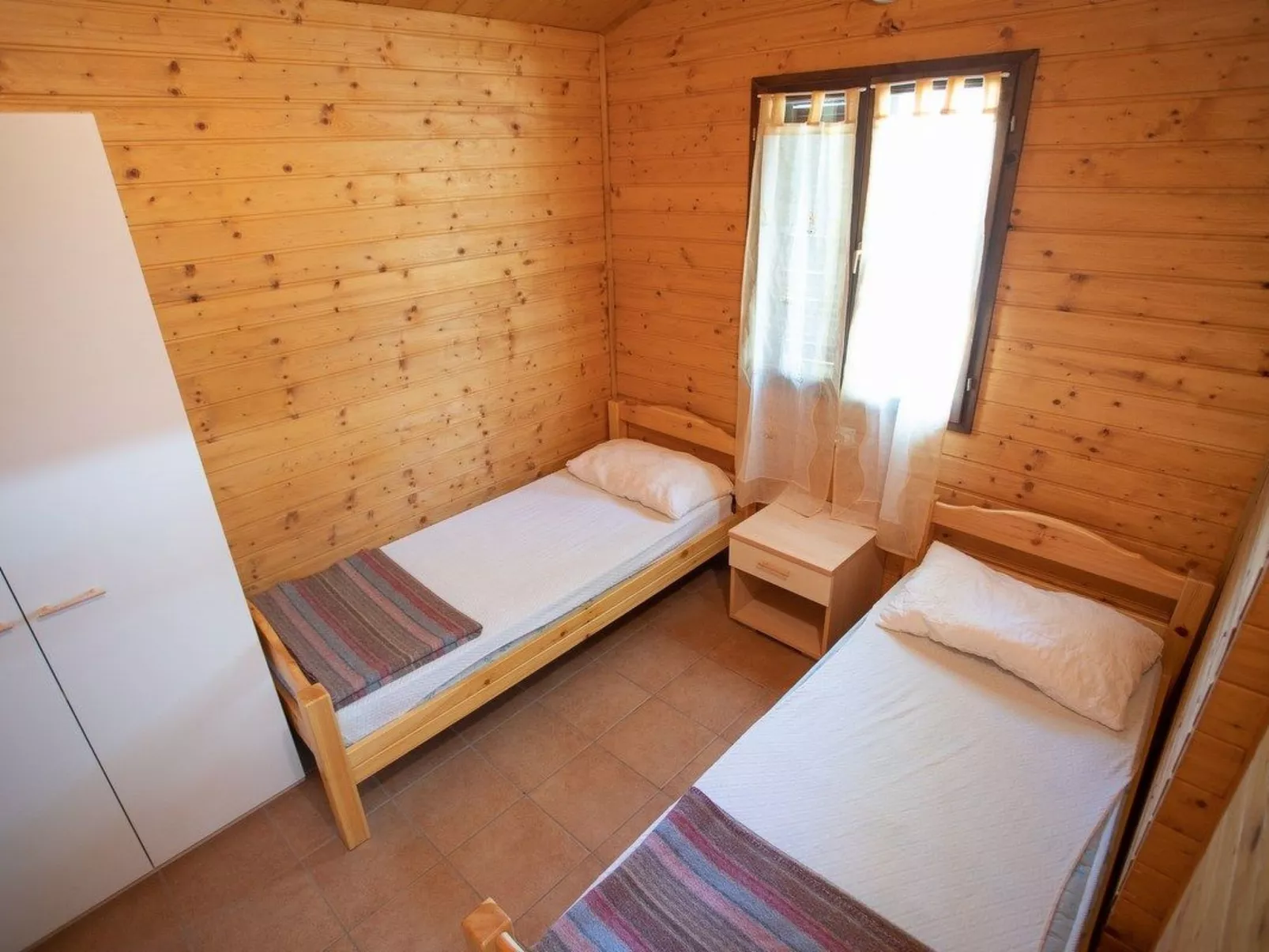 Bungalow aus Holz mit Veranda und nah am Strand.-Binnen