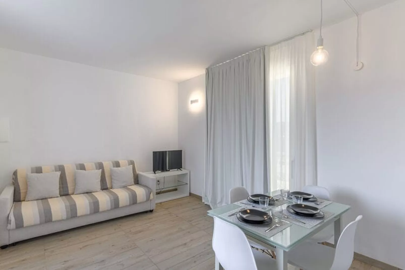 Residence Capo Falcone Stintino "Trilo 6 Premium"-Woonkamer