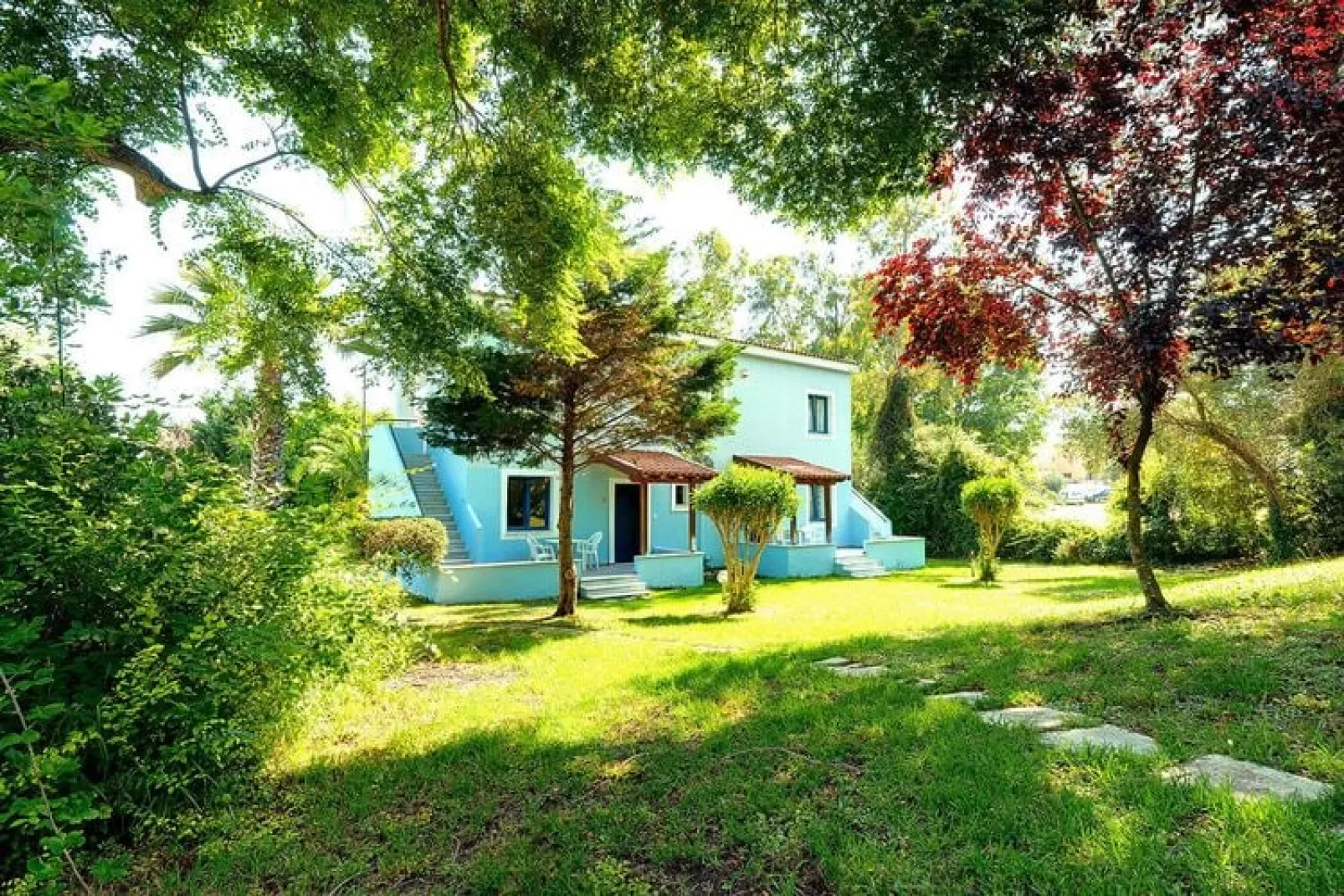 Appartement in Gouvia met een tuin-Buitenkant zomer